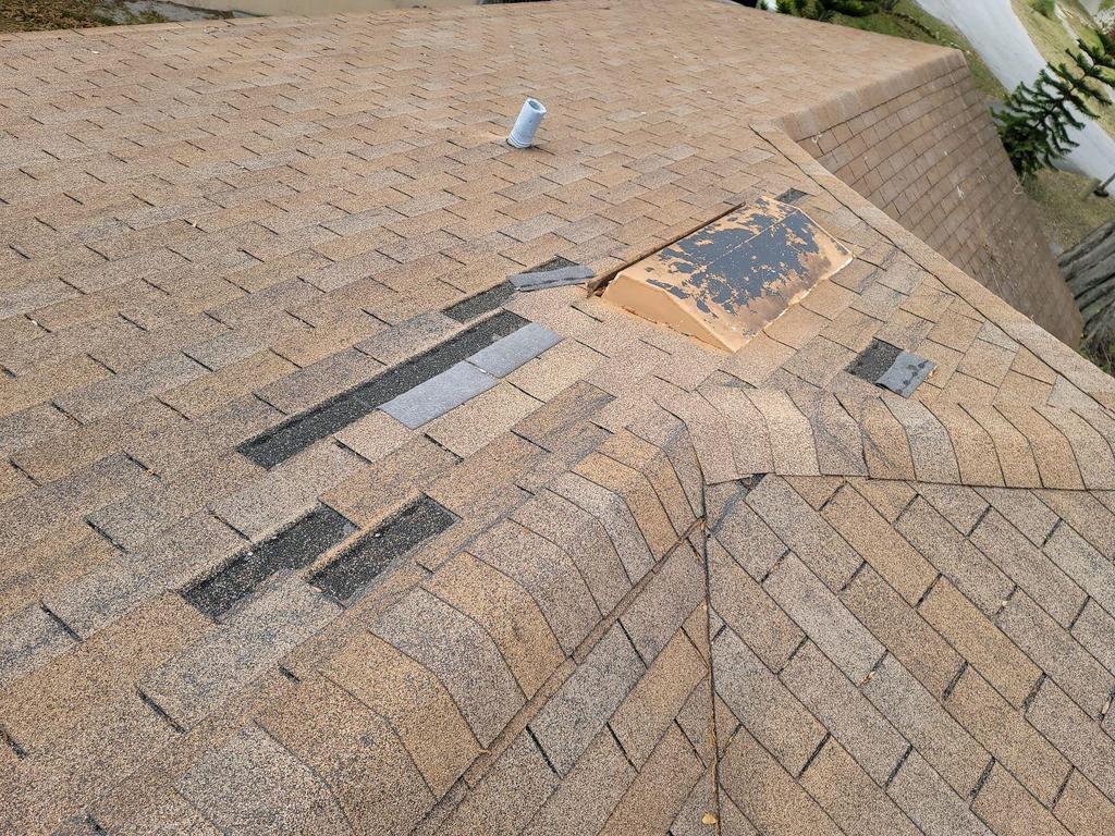 Damaged roof with missing shingles before Janja Group LLC repair in Davenport FL